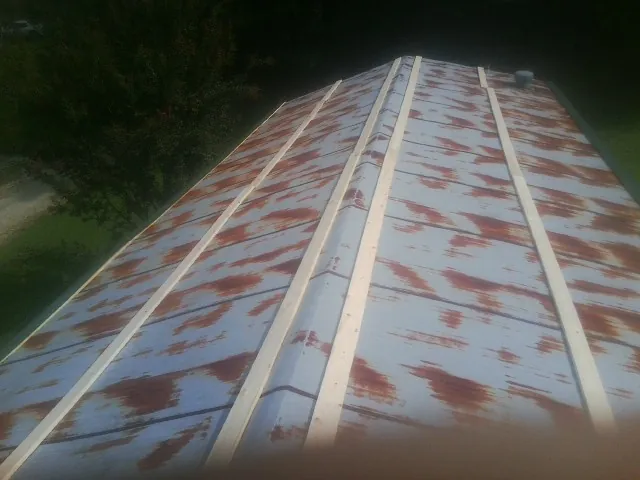 Rusted metal roof panels with new wood purlins before replacement — Storm Damage Roof Repair in Bowman by Roofing Brothers